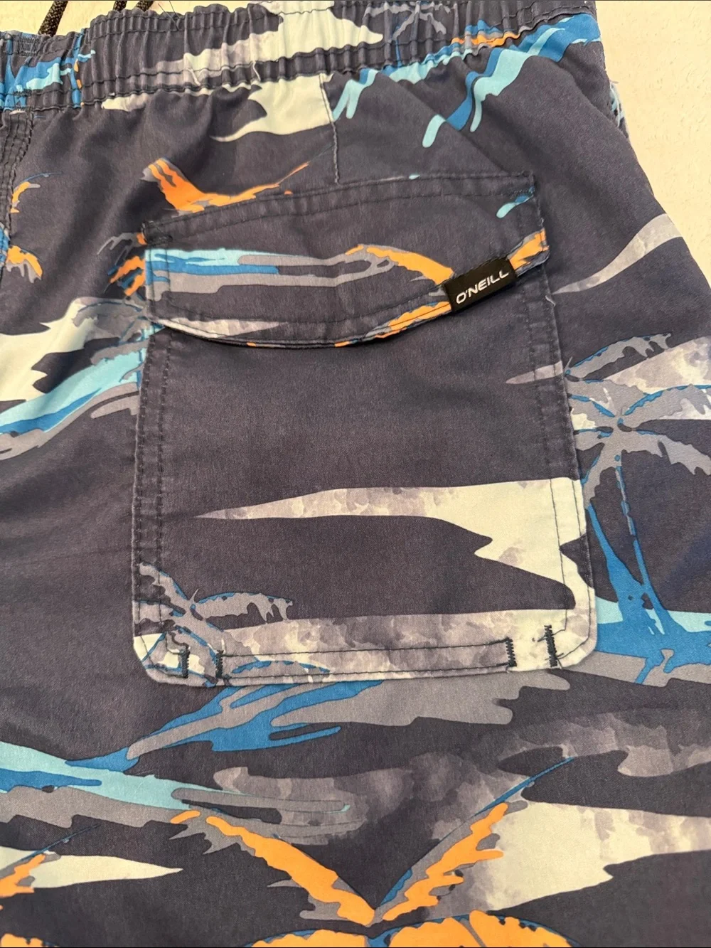 O’Neill bathing suit with two pockets one back pocket with Velcro